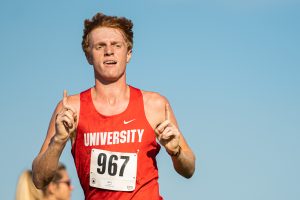 Ryan Blohm leads UHS cross-country to a perfect score; Irene Riggs leads MHS to another regional title
